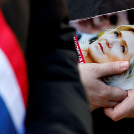 Un funcionario electo de Agrupación Nacional (RN) distribuye folletos en apoyo a la líder de extrema derecha francesa Marine Le Pen, en Henin-Beaumont, al 1 de abril de 2025.