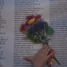 Una persona deposita un ramo de flores con los colores de la república en el XVII Homenaje a las víctimas del franquismo en Madrid, de Memoria y Libertad, en el Cementerio del Este, a 15 de abril de 2023, en Madrid (España).