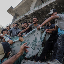 Varios desplazados palestinos recuperan un cuerpo de entre los escombros de un edificio destruido tras un ataque aéreo israelí en el barrio de Al Remal, en la ciudad de Gaza, a 3 de junio de 2025.