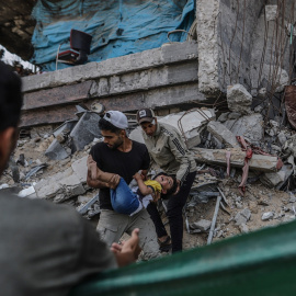Dos personas trasladan a un niño herido tras un ataque israelí en Ciudad de Gaza el pasado 3 de junio.
