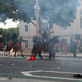 Policías a caballo intentan contener una protesta en Los Angeles este lunes.