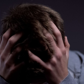 Imagen de stock de un hombre con las manos sobre la cabeza