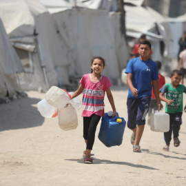 (Foto de ARCHIVO)26 July 2025, Palestinian Territories, Gaza: Palestinian children try to meet their daily water needs by filling jerry cans from water tankers brought into the area in Gaza city, on July 26, 2025. In the Gaza Strip, which remains under Israeli attacks, Palestinians are struggling to survive under extremely harsh conditions, as Israel continues to deprive Palestinians from even the most basic necessities from such as shelter, food, and clean water. Photo: Omar Ashtawy/APA Images via ZUMA Press Wire/dpaOmar Ashtawy/APA Images via ZUMA / DPA26/7/2025 ONLY FOR USE IN SPAIN