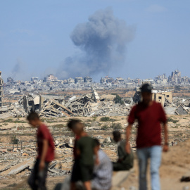 Palestinos observan una columna tras un bombardeo israelí en la Franja de Gaza.