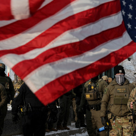 Bandera estadounidense al revés junto a agentes del Servicio de Inmigración y Control de Aduanas (ICE)