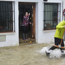 Vecinos de Grazalema (Cádiz) intentan achicar agua de sus casa y locales inundados por las intensas lluvias