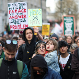 Manifestante sujetando una pancarta exigiendo esperanza en vez de odio.