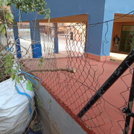Una zona del pati de l'escola Àngels Garriga de Barcelona amb la valla malmesa