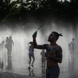 Varias personas se refrescan en las fuentes de Madrid Río.