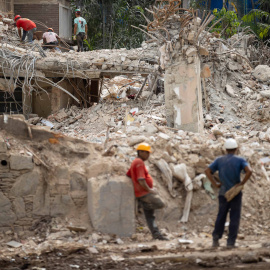 Personas retiran este jueves escombros de un edificio afectado por el doble terremoto en Caracas (Venezuela).