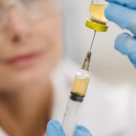 high-angle-defocused-female-scientist-using-syringe (1)