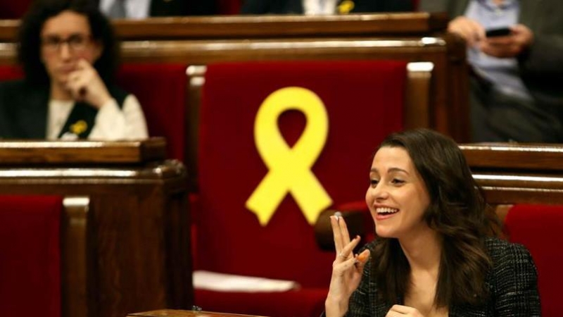 La líder de C's al Parlament, Inés Arrimadas, amb la número 2 d'ERC, Marta Rovira, en segon pla, al costat d'un llaç vermell a l'escó bit que correspon a Oriol Junqueras, en el ple d'aquest dijous. EFE / Toni Albir