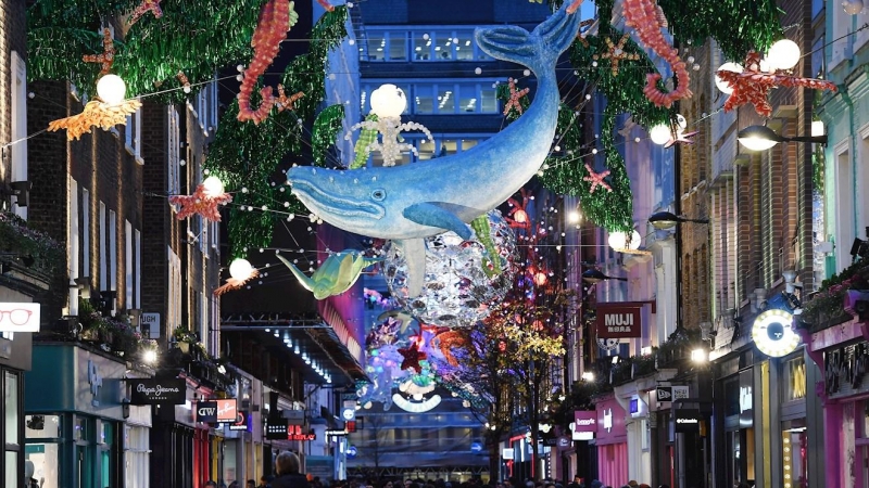 Peatones caminan bajo las luces de Navidad en Carnaby Street en Londres, (R.Unido). EFE/ANDY RAIN