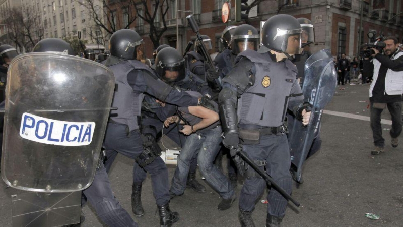 Un manifestante es detenido por varios miembros de la Policía Nacional durante la protesta 'Rodea el Congreso' en 2013. -EFE