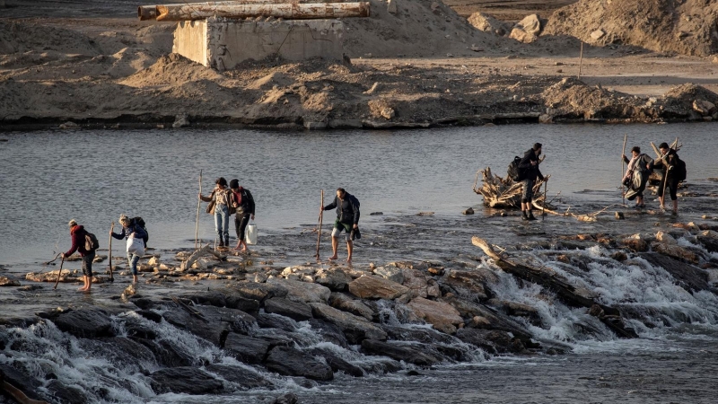 Un grupo de refugiados cruza por el río Meric la frontera griega. REUTERS/Marko Djurica