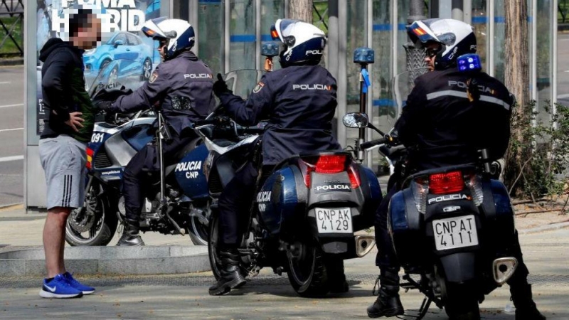 Agentes de la Policía hablando con un viandante. / EFE