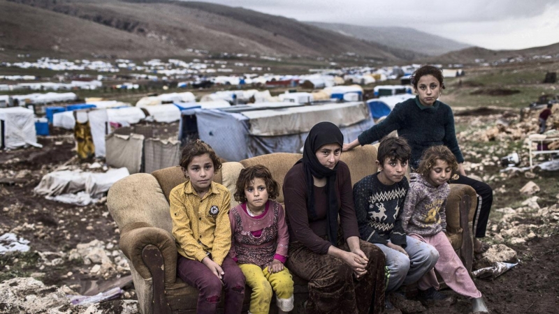 Dilbrin, de 29 años, esta sentada junto a sus 5 hijos en un sofá en el campo de refugiados Serdasht, situado en lo alto de la montaña de Sinjar. JM López