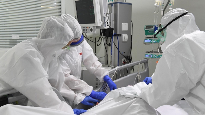 Pla mig dels sanitaris amb un pacient a la UCI de l'Hospital de Manresa (Althaia). Imatge del 24 d'abril de 2020 (Horitzontal).  Foto en Alta