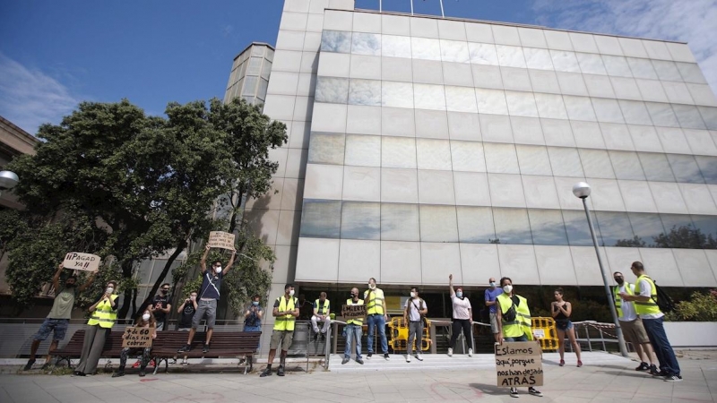 Una docena de trabajadores afectados por ERTE de fuerza mayor y que todavía no han cobrado el paro protestan ante la delegación del SEPE en Barcelona. /EFE