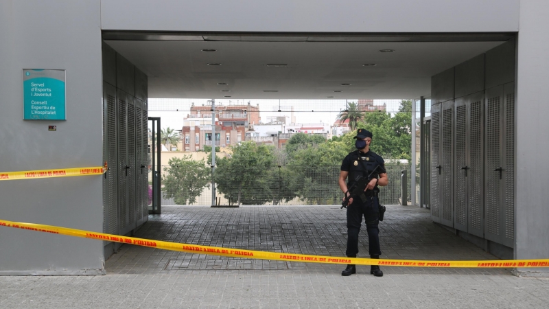 Un agent de la Policia Nacional durant l'operació al Consell Esportiu de l'Hospitalet. ACN / ÀLEX RECOLONS