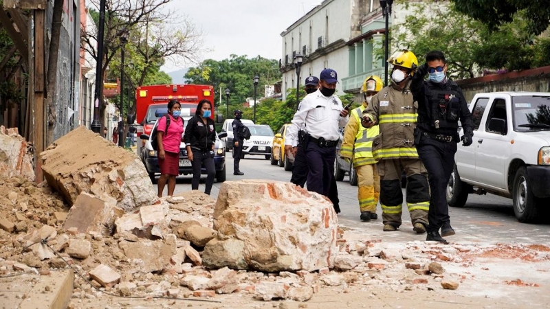 23/06/2020.- Miembros de la policía y de los bomberos observan los daños causados en una barda derrumbada este martes, en la ciudad de Oaxaca (México). El terremoto de magnitud 7,5 que sacudió este martes con fuerza el centro y sur de México ha dejado al