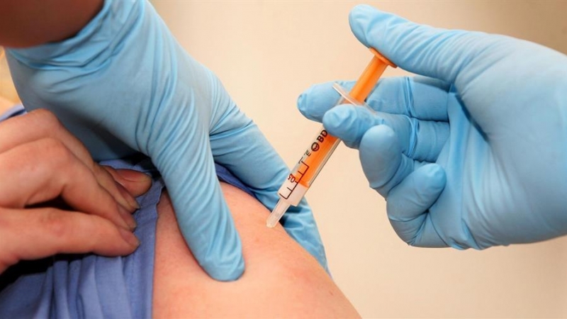 Un trabajador sanitario recibe una dosis de la vacuna contra la gripe A / EFE / Lewis Whyld