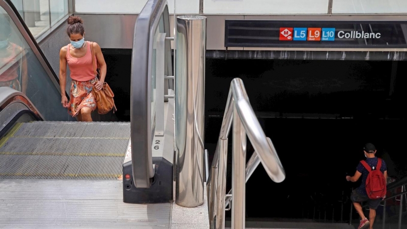 14/07/2020.-Varias personas salen de la estación de metro de Collbanc, una de las muchas estaciones de L'Hospitalet que comparte trayecto con Barcelona. / EFE - TONI ALBIR