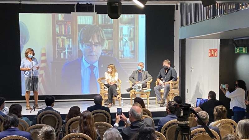 Un moment de la presentació del llibre a la llibreria Ona, amb Puigdemont intervenint per videoconferència.