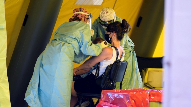 Personal sanitario realiza pruebas PCR a un niño en el colegio José María Pereda del barrio de La Inmobiliaria en la ciudad cántabra de Torrelavega. /EFE