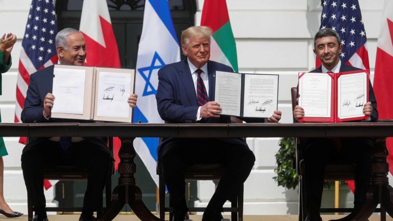 El primer ministro de Israel, Benjamin Netanyahu, el presidente de los Estados Unidos, Donald Trump, y el ministro de Relaciones Exteriores de los Emiratos Árabes Unidos (EAU), Abdullah bin Zayed, muestran sus copias de los acuerdos firmados mientras part