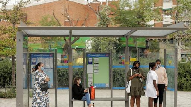 Varias mujeres esperando el autobus en una parada del barrio madrileñoi de Usera.  REUTERS/Javier Barbancho