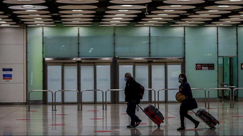 Dos personas en el aeropuerto de Barajas en Madrid / EFE