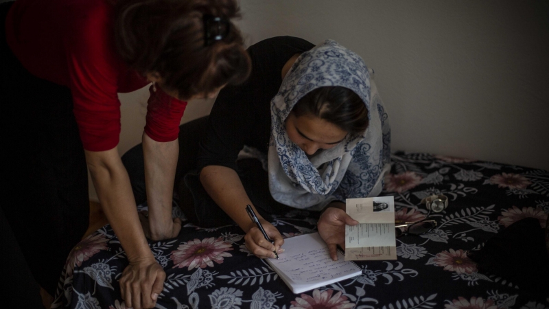 Dos de las chicas afganas revisan su documentación de asilo.- JAIRO VARGAS