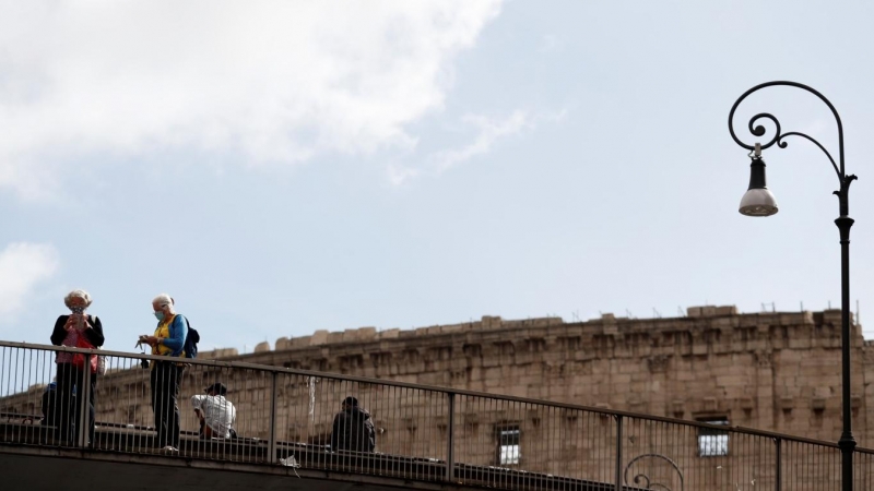 Dos mujeres llevan mascarillas cerca del Coliseo romano en Italia. REUTERS / Yara Nardi