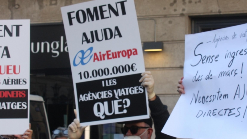 Cartells reivindicatius a la protesta del sector de les agències de viatges, a les portes de la Generalitat.