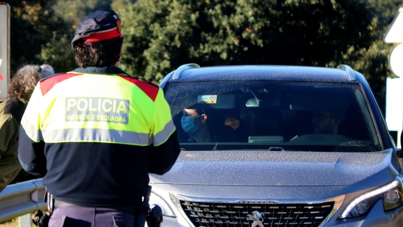 Un Agent Rural i un Mosso d'Esquadra aturant un vehicle que pretén entrar al Parc Natural del Montseny a través del Brull.