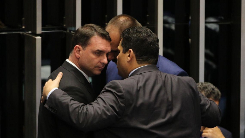 26/12/2020. El senador Flávio Bolsonaro, junto al presidente del Senado, Davi Alcolumbre (de espaldas), y su hermano el diputado federal Eduardo Bolsonaro. - Agência Brasil