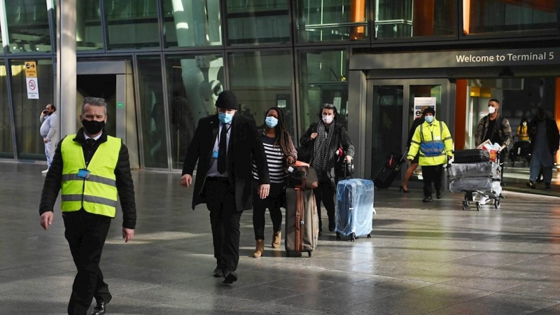 Viajeros internacionales son escoltados a su llegada al aeropuerto londinense de Heathrow hasta el Radison Blu Hotel, donde tienen que hacer cuarentena.
