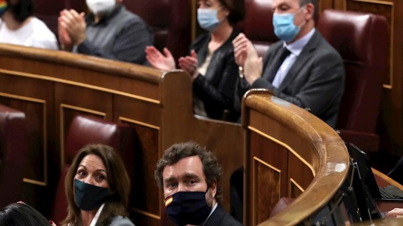 Parlamentarios aplauden durante el pleno del Congreso de los Diputados, a excepción de los diputados de Vox.