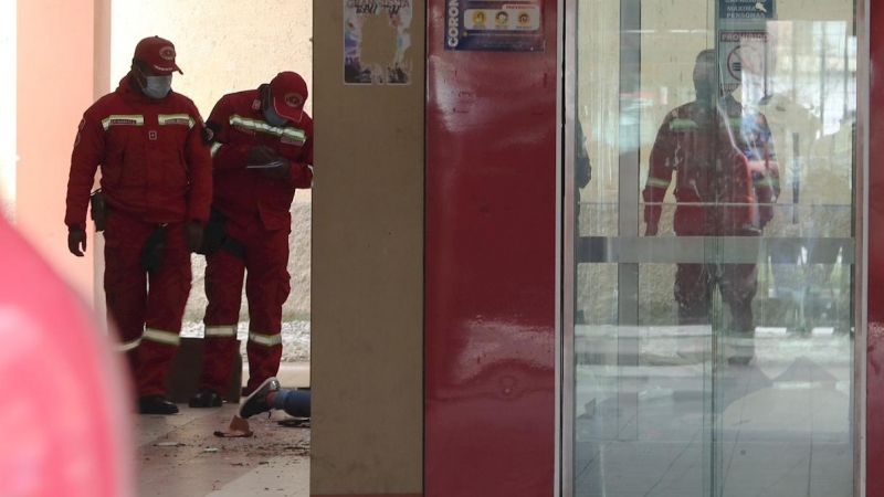 Varios bomberos inspeccionan el lugar del accidente el que murieron varios estudiantes de la Universidad de El Alto (Bolivia).