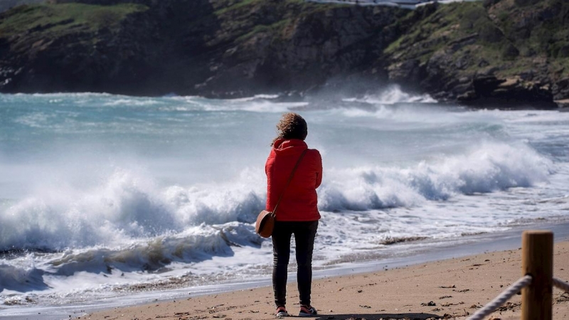 Una mujer observa el fuerte oleaje en la cala Sa Mesquida de Mahón, Menorca