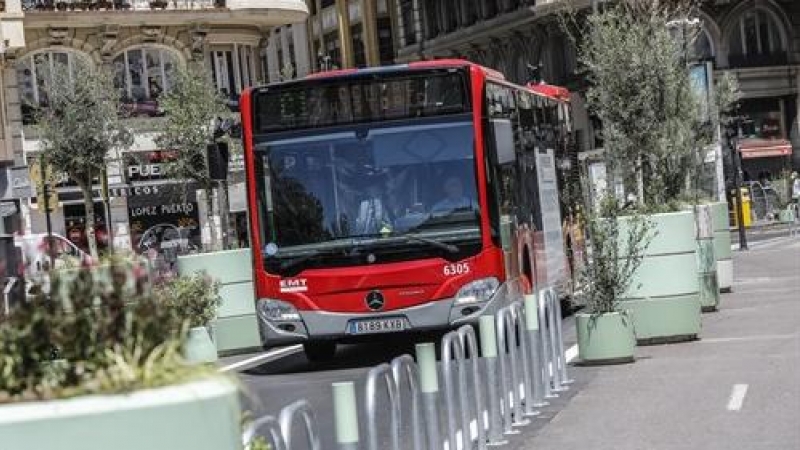 Un autobús de la línea C1 pasa al lado de los maceteros colocados en la Plaza del Ayuntamiento de Valencia.