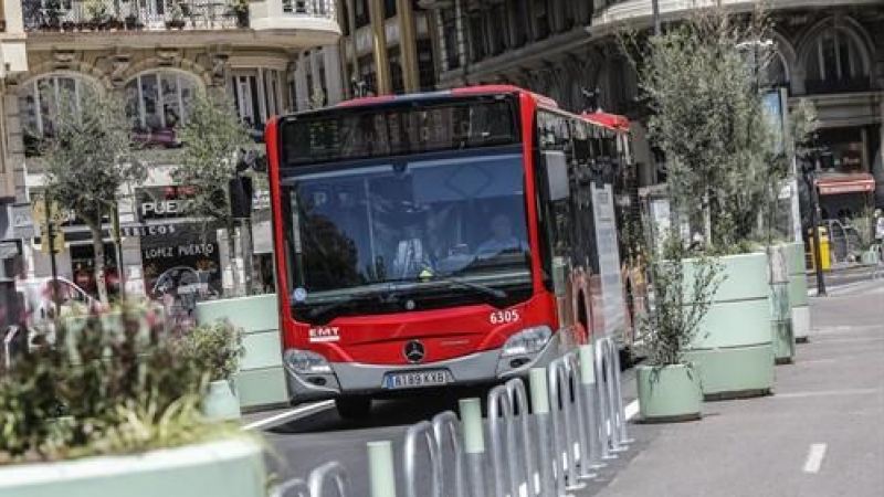 Un autobús de la línea C1 pasa al lado de los maceteros colocados en la Plaza del Ayuntamiento de Valencia.