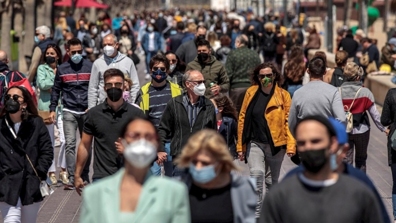 Cientos de personas caminan por el paseo marítimo de la Malvarrosa de València.