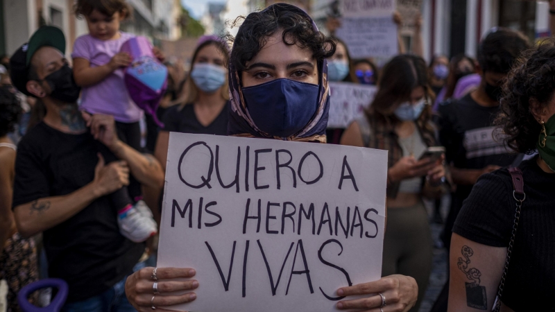 Mujer con pancarta 'quiero vivas a mis hermanas'. Foto de archivo.