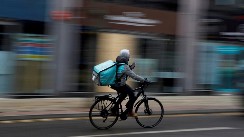 Un repartidor de Deliveroo, en su bicicleta por el centro de Manchester (Reino Unido). REUTERS/Phil Noble