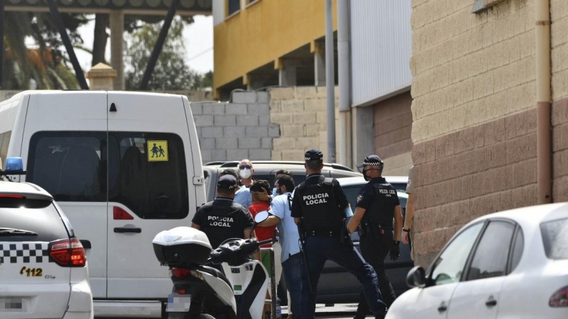 Varios agentes acompañan a menores no acompañados hacia una furgoneta en Ceuta