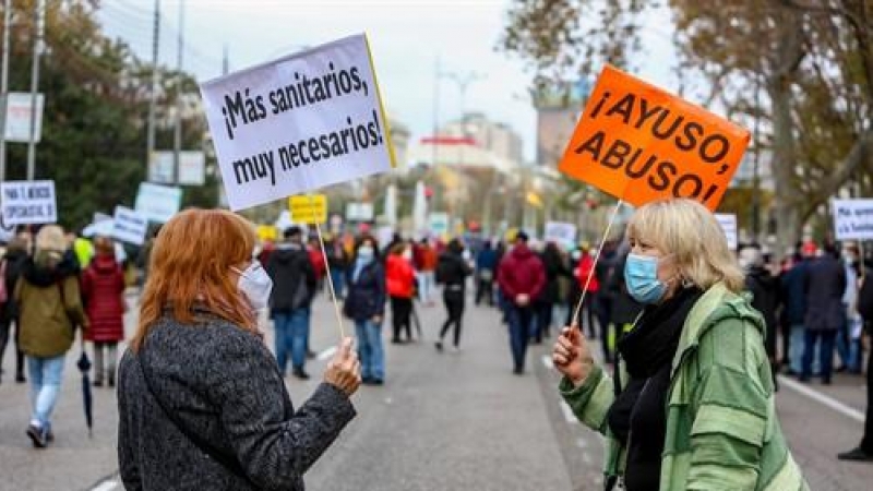 Una mujer sostiene una pancarta donde se lee '¡Más sanitarios, muy necesarios!' durante una manifestación de la Marea Blanca en Madrid, a 29 de noviembre de 2020.