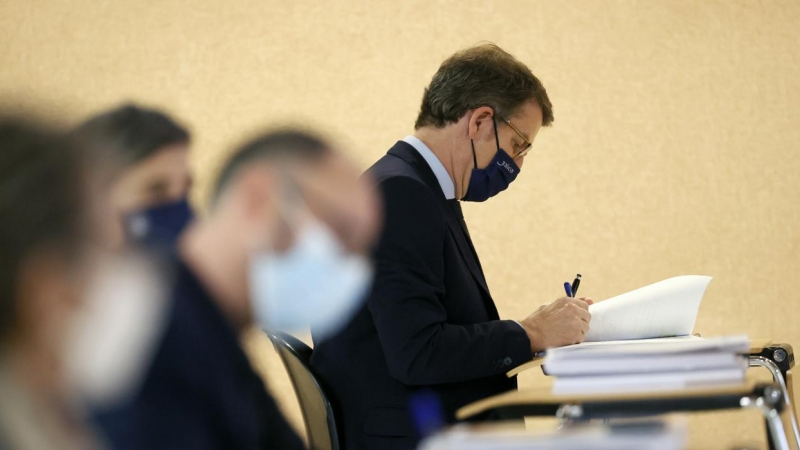 El presidente de la Xunta, Alberto Núñez Feijóo, sentado entre los periodistas durante la intervención del conselleiro de Economía, Miguel Corgos, durante la rueda de prensa posterior al Consello de la Xunta, en Santiago de Compostela. EFE/Lavandeira jr