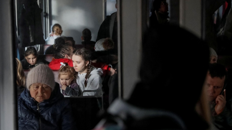 La gente se pone de pie y se sienta en un tren de evacuación de Kiev a Lviv, en la estación central de trenes de Kiev, en Kiev